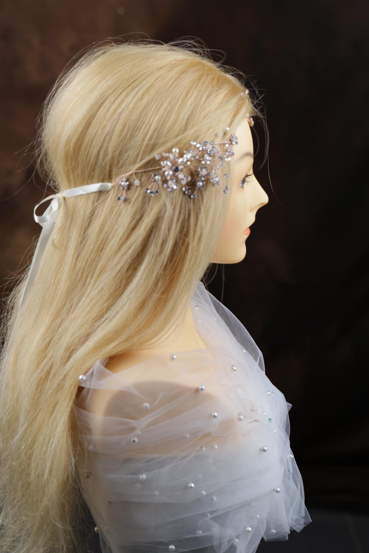 a mannequin head wearing a veil and a head piece