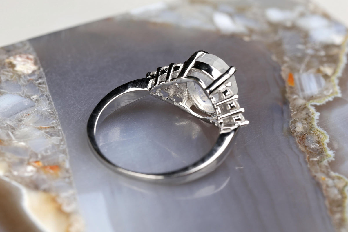a silver ring sitting on top of a rock