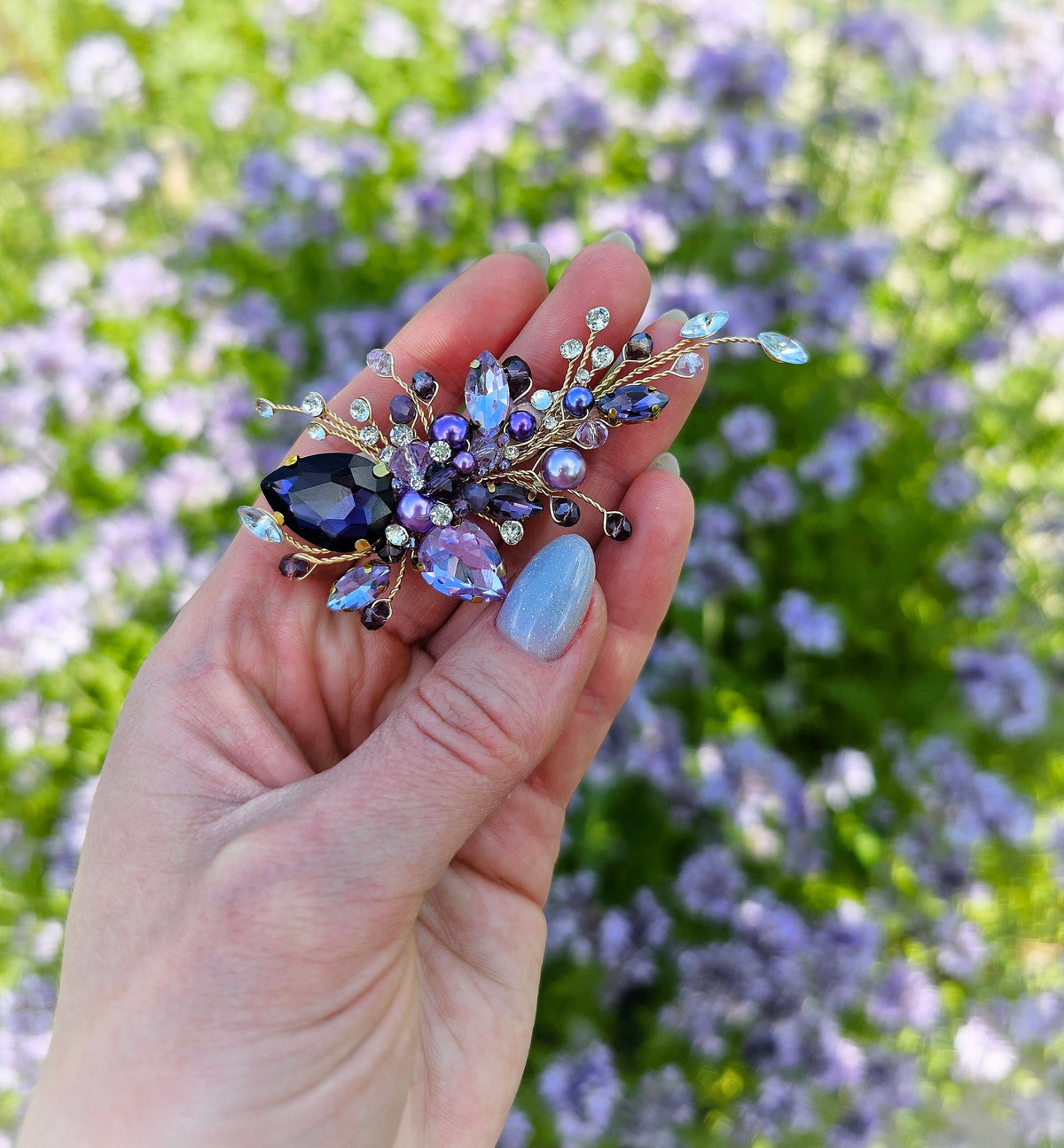 a person holding a brooch in their hand