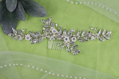 a close up of a hair comb on a green cloth