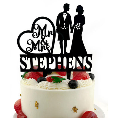 a wedding cake with a cake topper that says mr and mrs