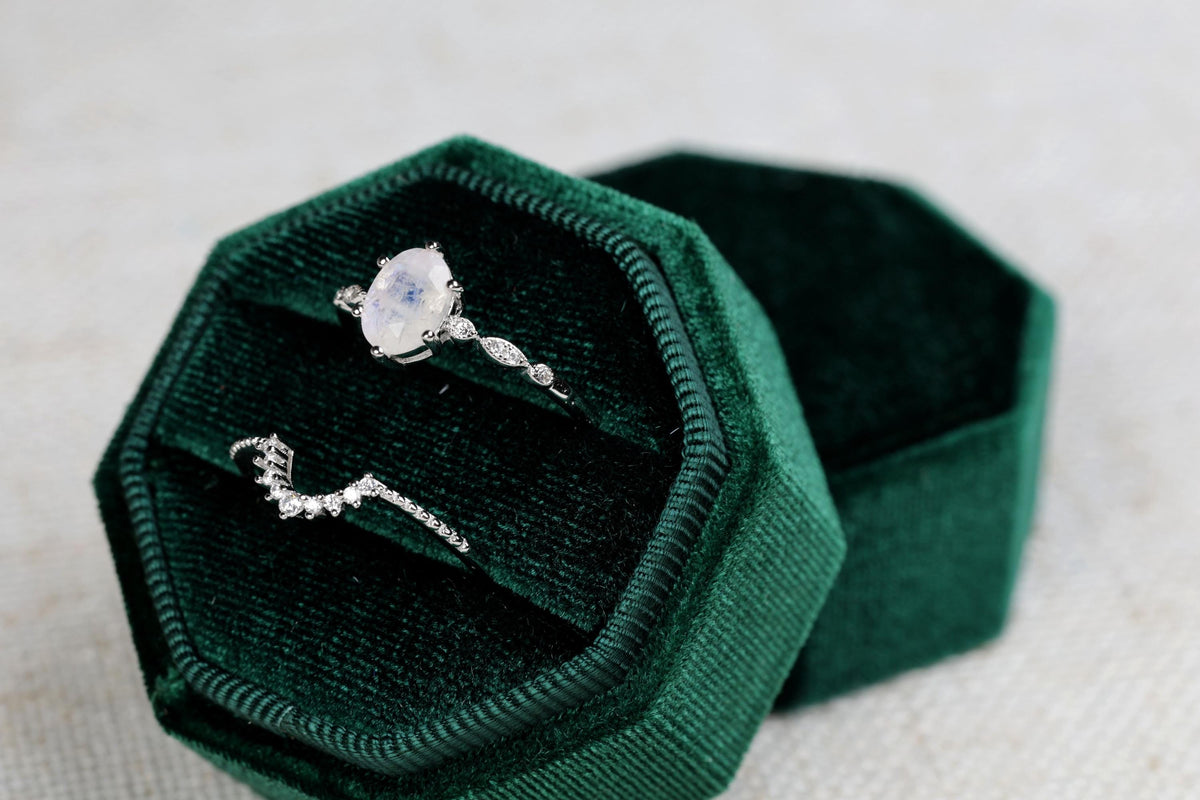 a ring sits inside of a velvet box