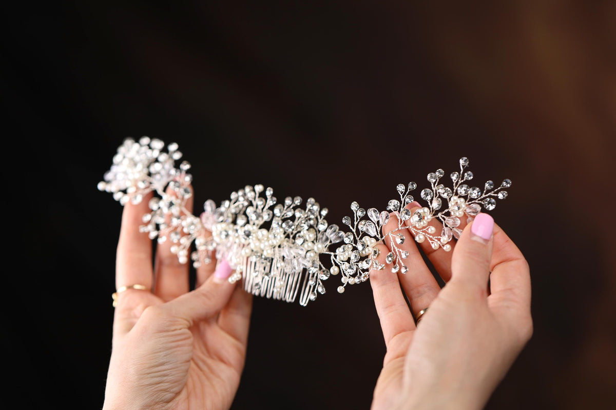 a close up of a person holding a hair comb