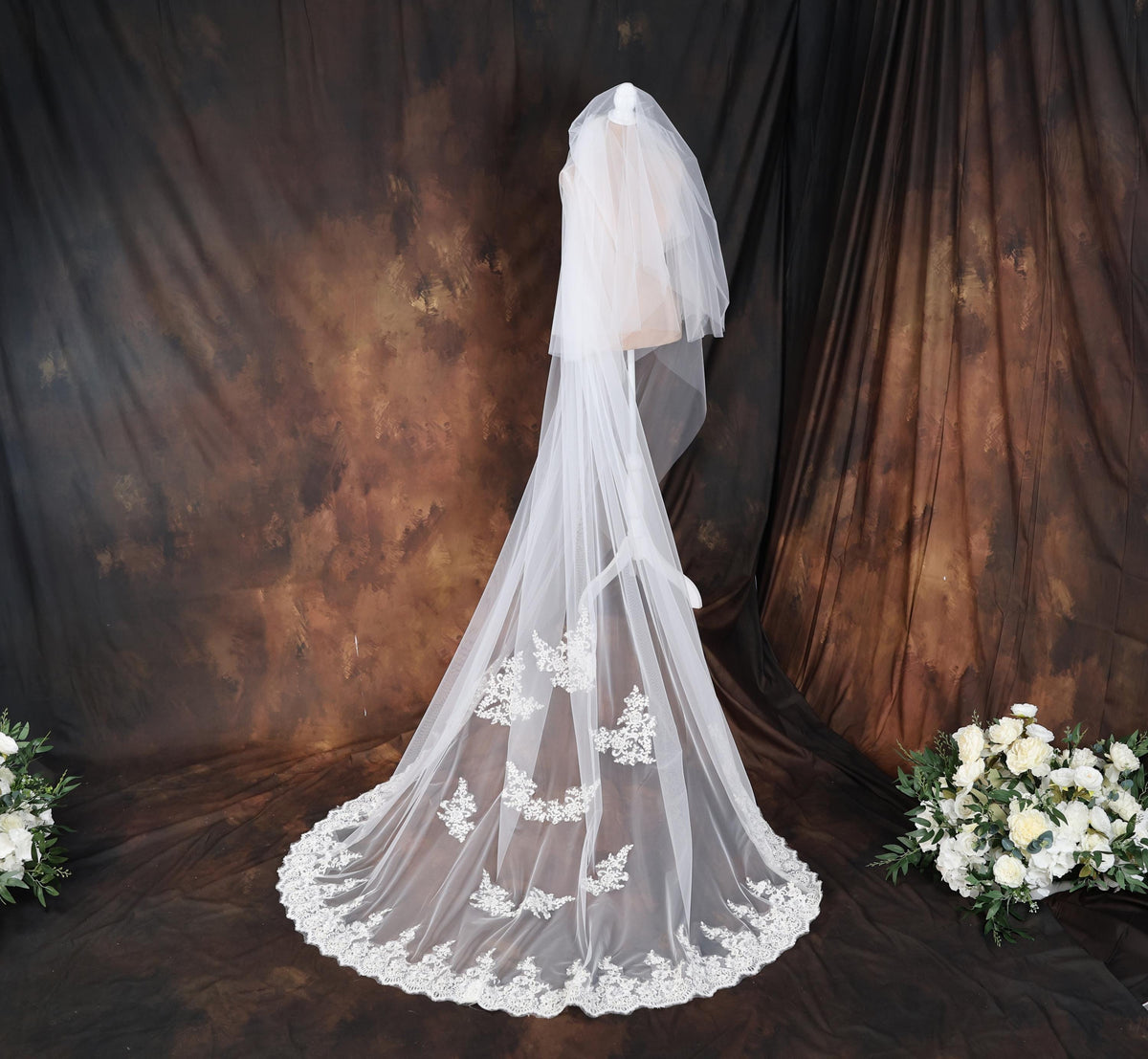 a bridal veil and bouquet of white flowers
