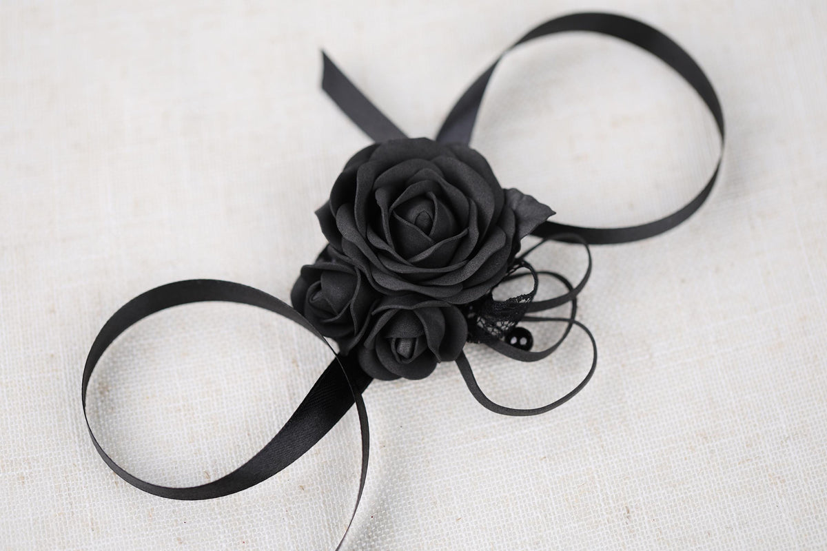 a black rose on a black ribbon on a white background