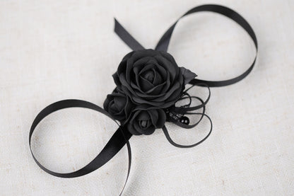 a black rose on a black ribbon on a white background