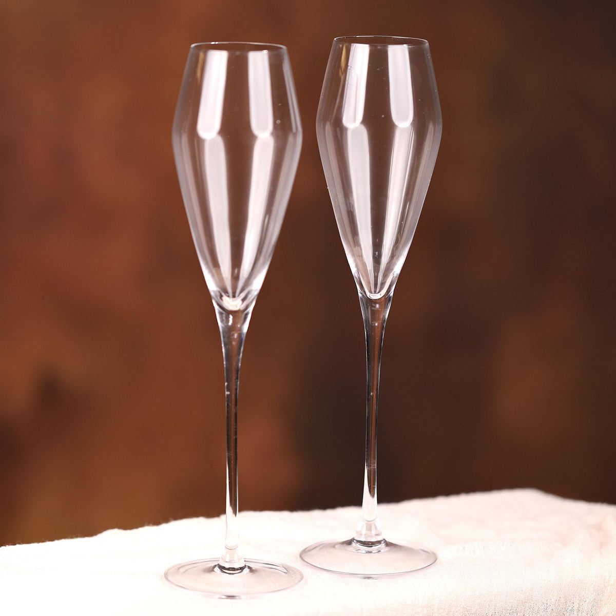 a pair of wine glasses sitting on top of a table