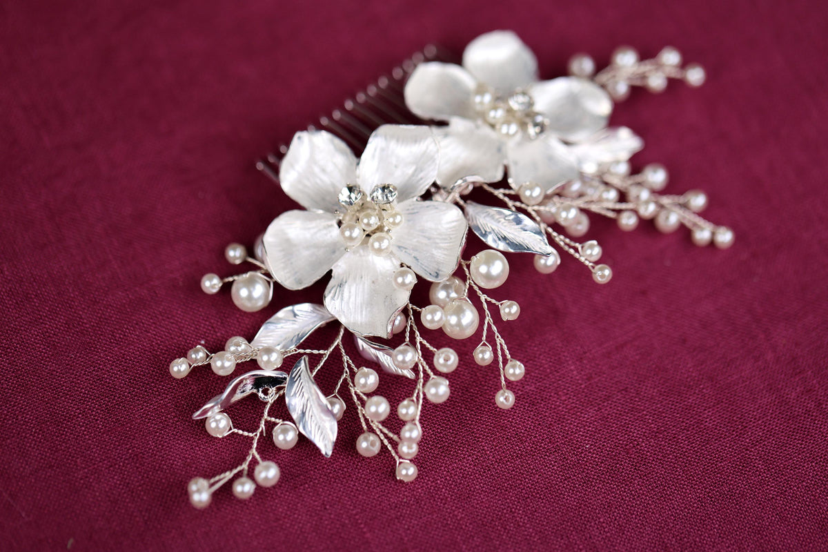 a close up of a hair comb with flowers and pearls