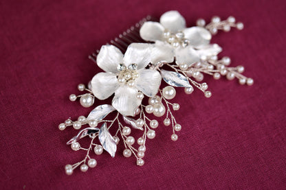 a close up of a hair comb with flowers and pearls