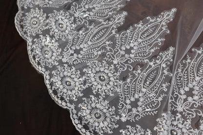 a close up of a white lace on a piece of cloth