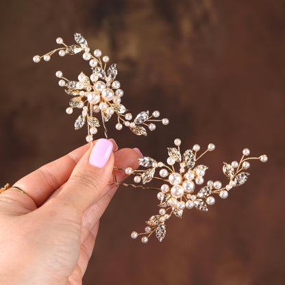 a hand holding a tiara with pearls on it