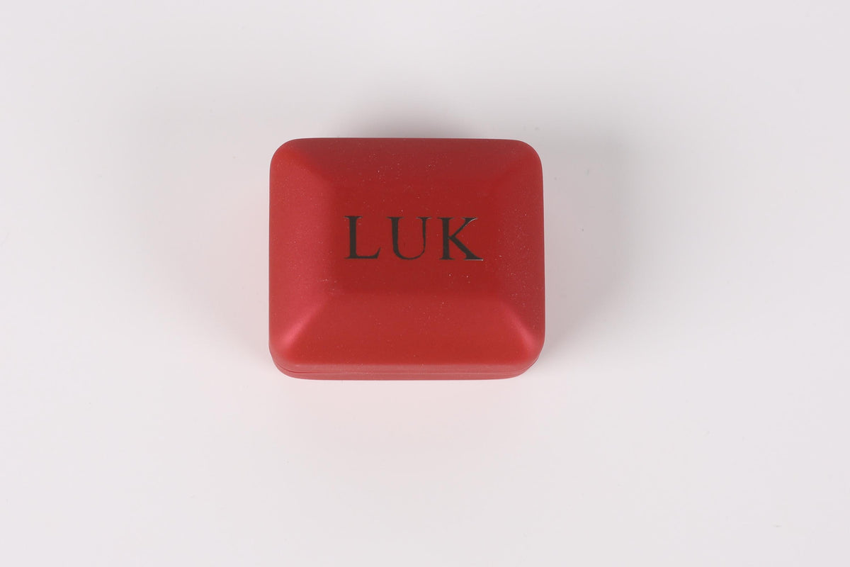 A red square box with the word "LUK" printed on it.