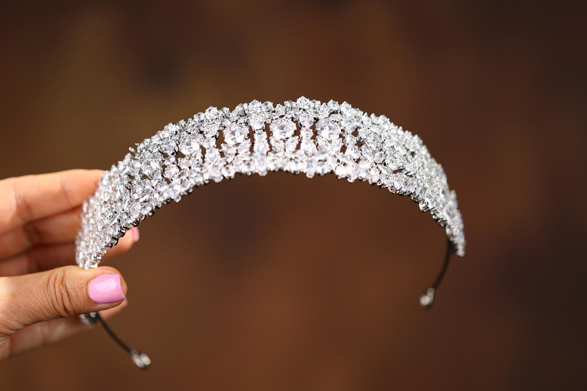 a woman holding a tiara in her hand