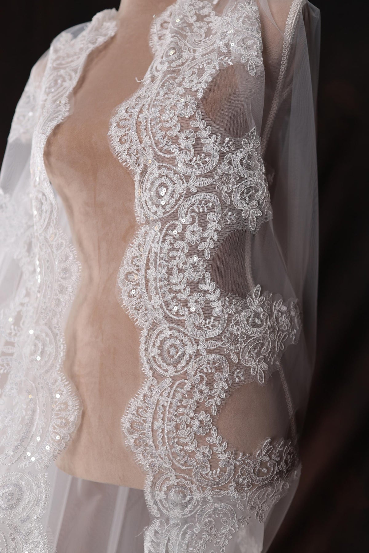 a mannequin wearing a white dress with a sheer top