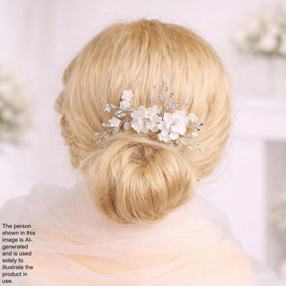 A close-up of a woman's blonde hair with a decorative hair accessory featuring white flowers.