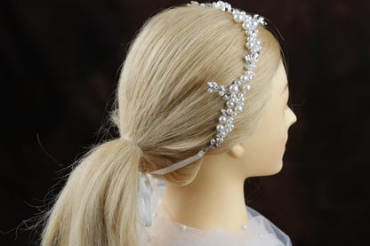 a blonde wig with a headband made of pearls
