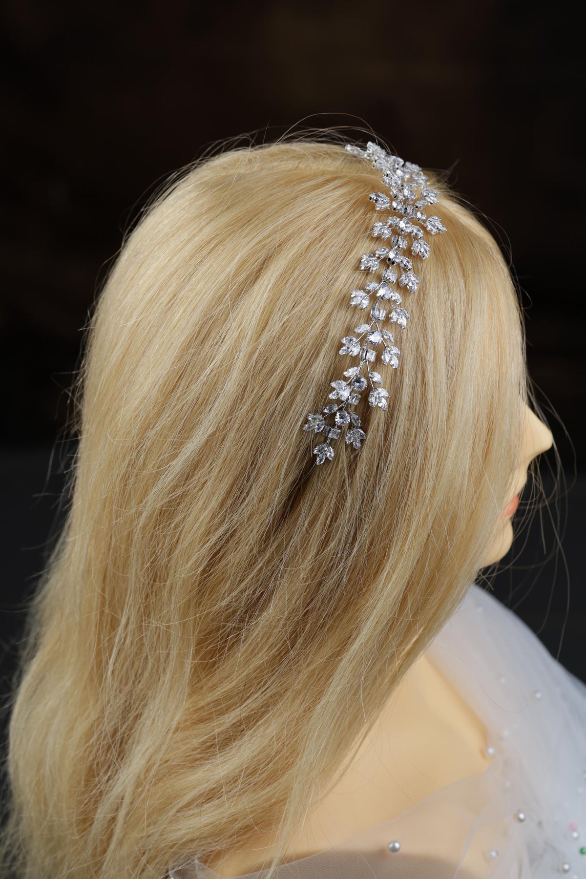 a close up of a woman's head wearing a hair comb