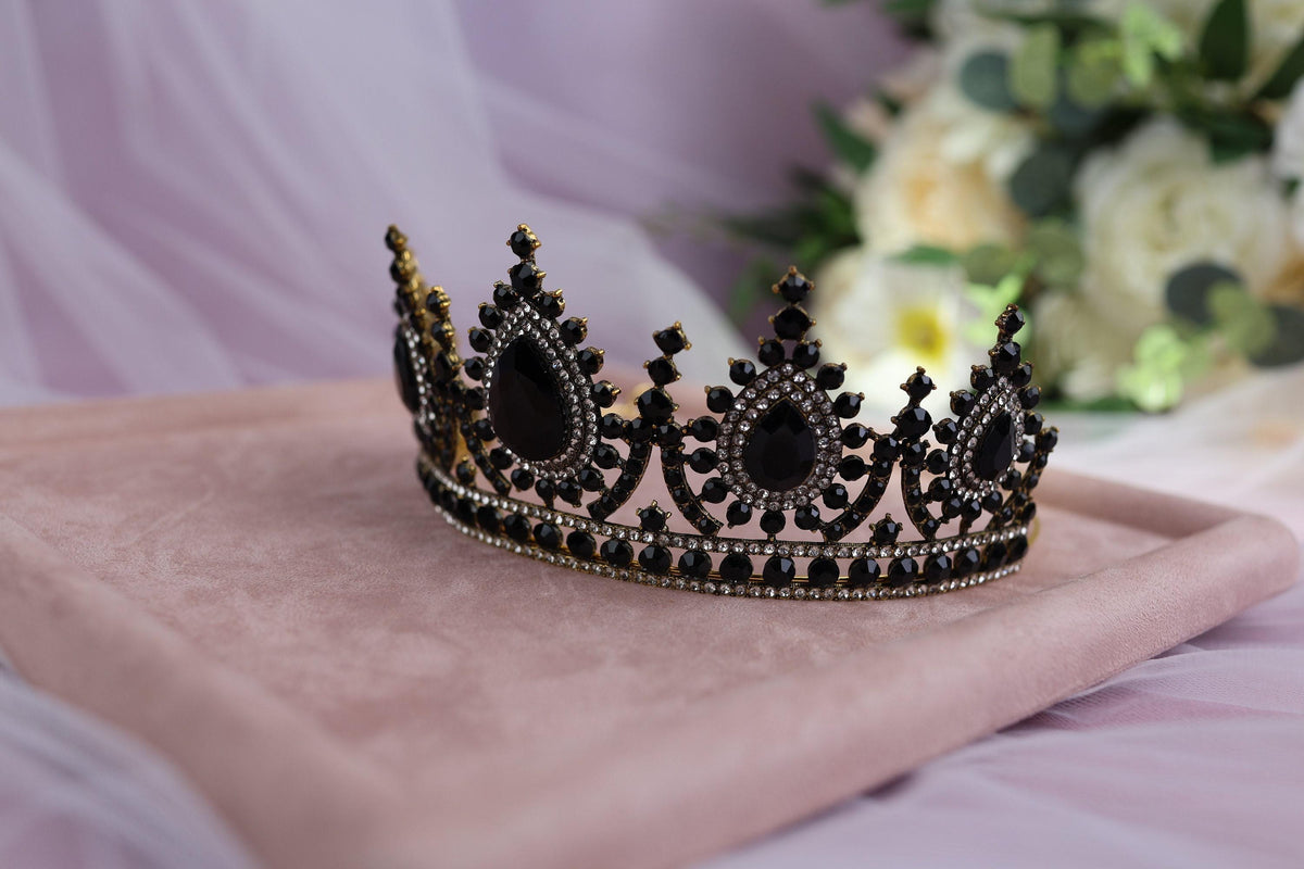 a crown sitting on top of a pink blanket