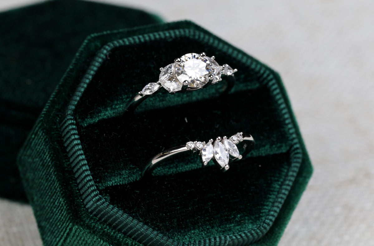 a couple of rings sitting inside of a green velvet box
