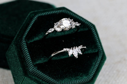 a couple of rings sitting inside of a green velvet box