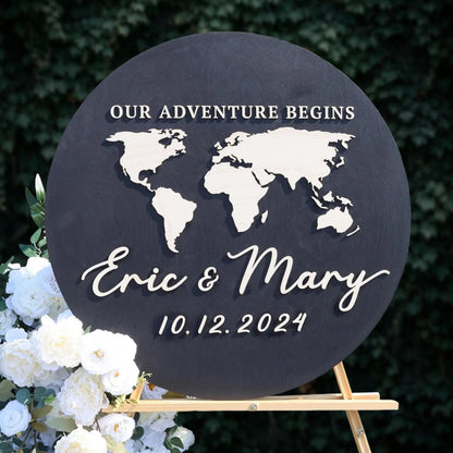 A black sign with a world map and the names "Eric & Mary" written on it, along with the date "10.12.2024".