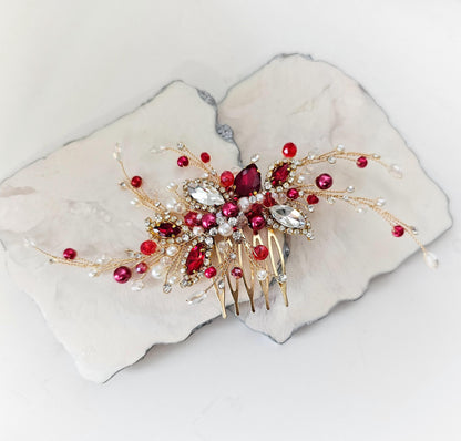 a white plate with a red and gold hair comb on it