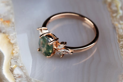 a close up of a ring with a green stone