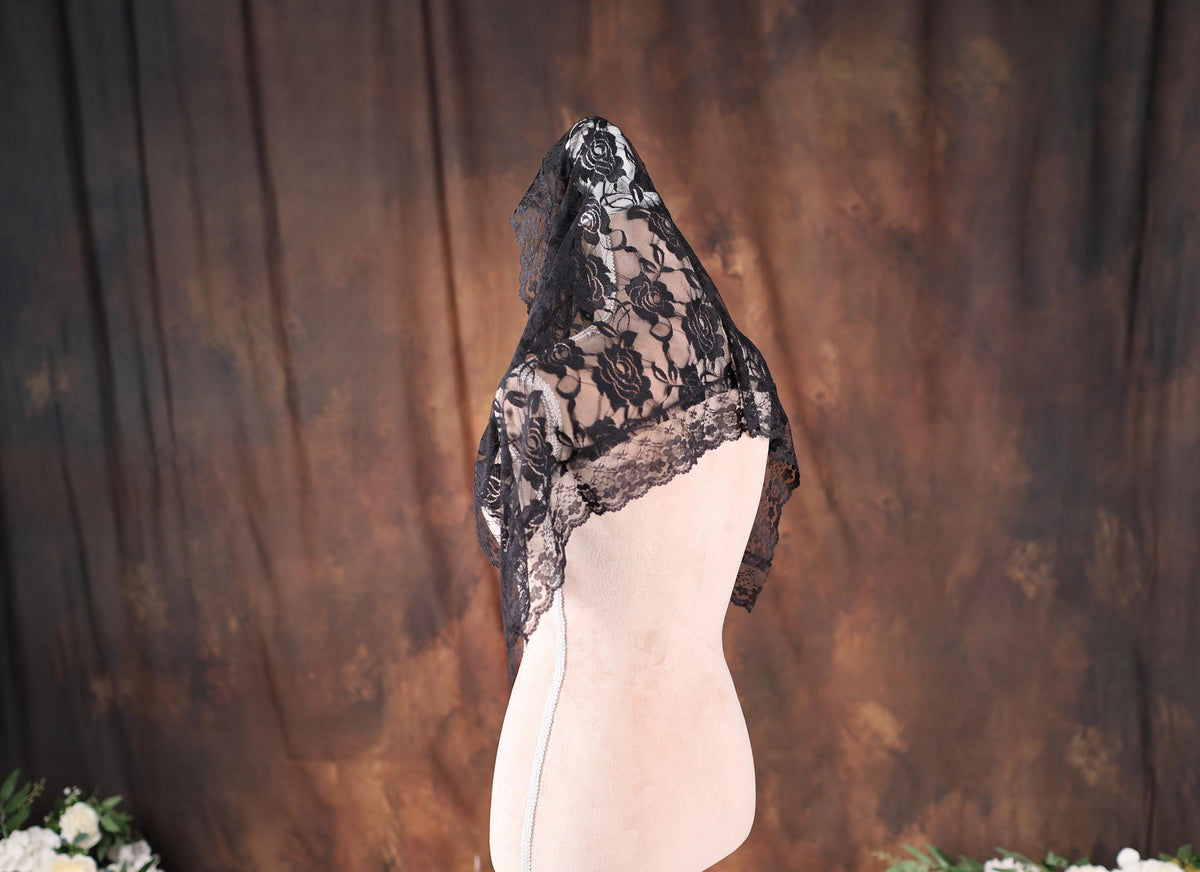 a mannequin with a black lace top on it