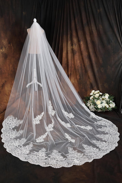 a white wedding veil with a bouquet of flowers
