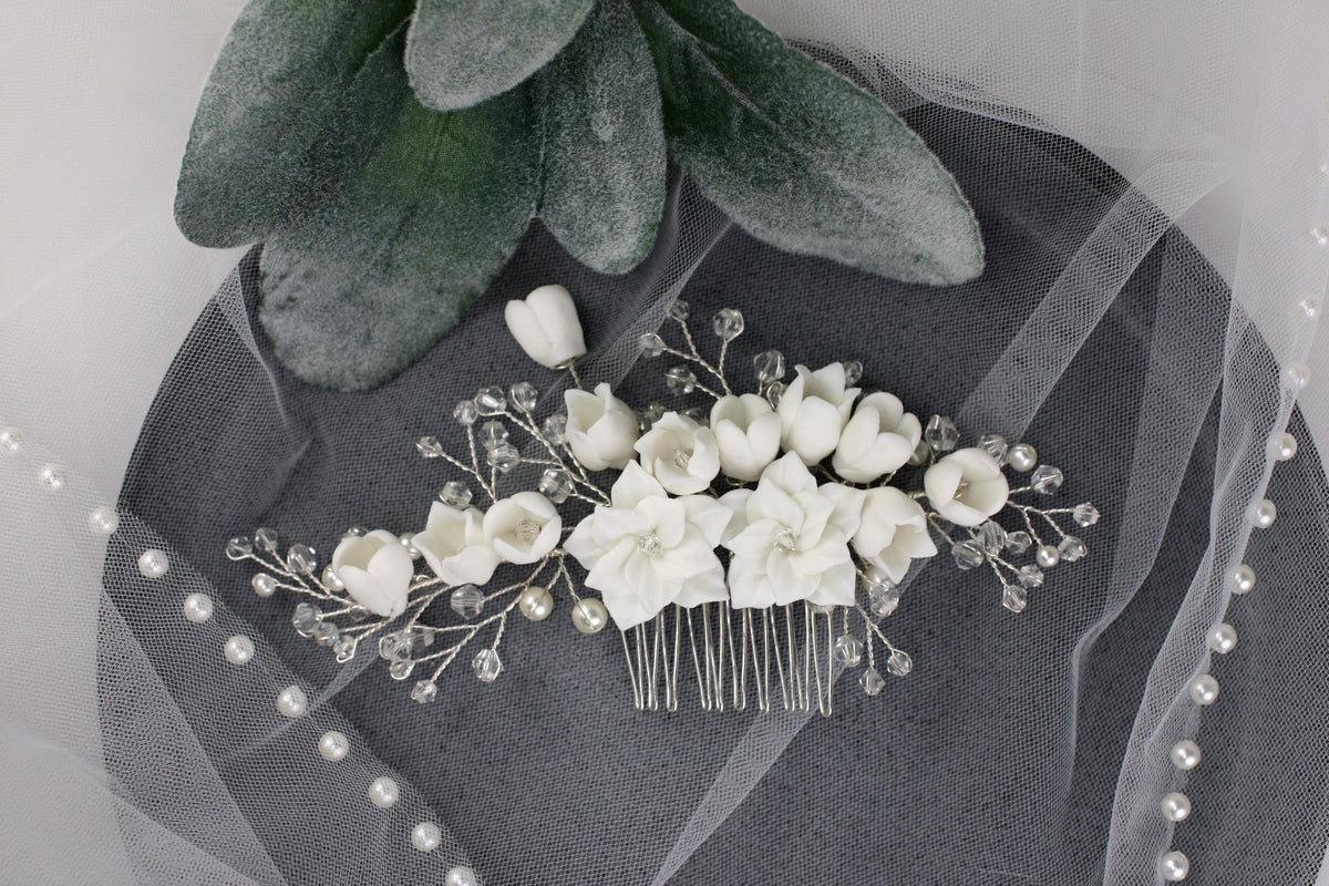 a bridal hair comb with white flowers and pearls