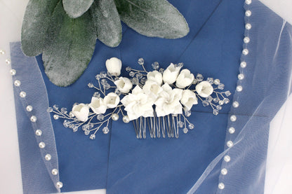 a bridal hair comb with flowers and pearls