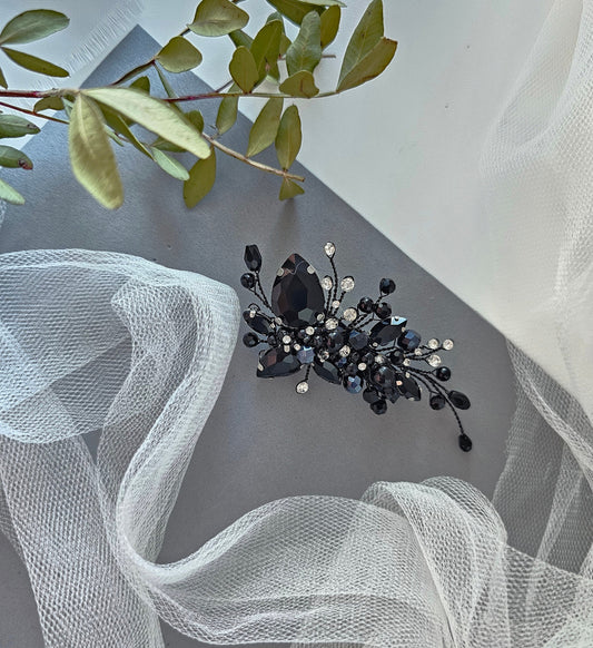 a black and white brooch sitting on top of a table