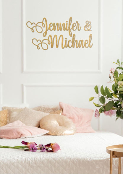 a white bed with pink and gold pillows