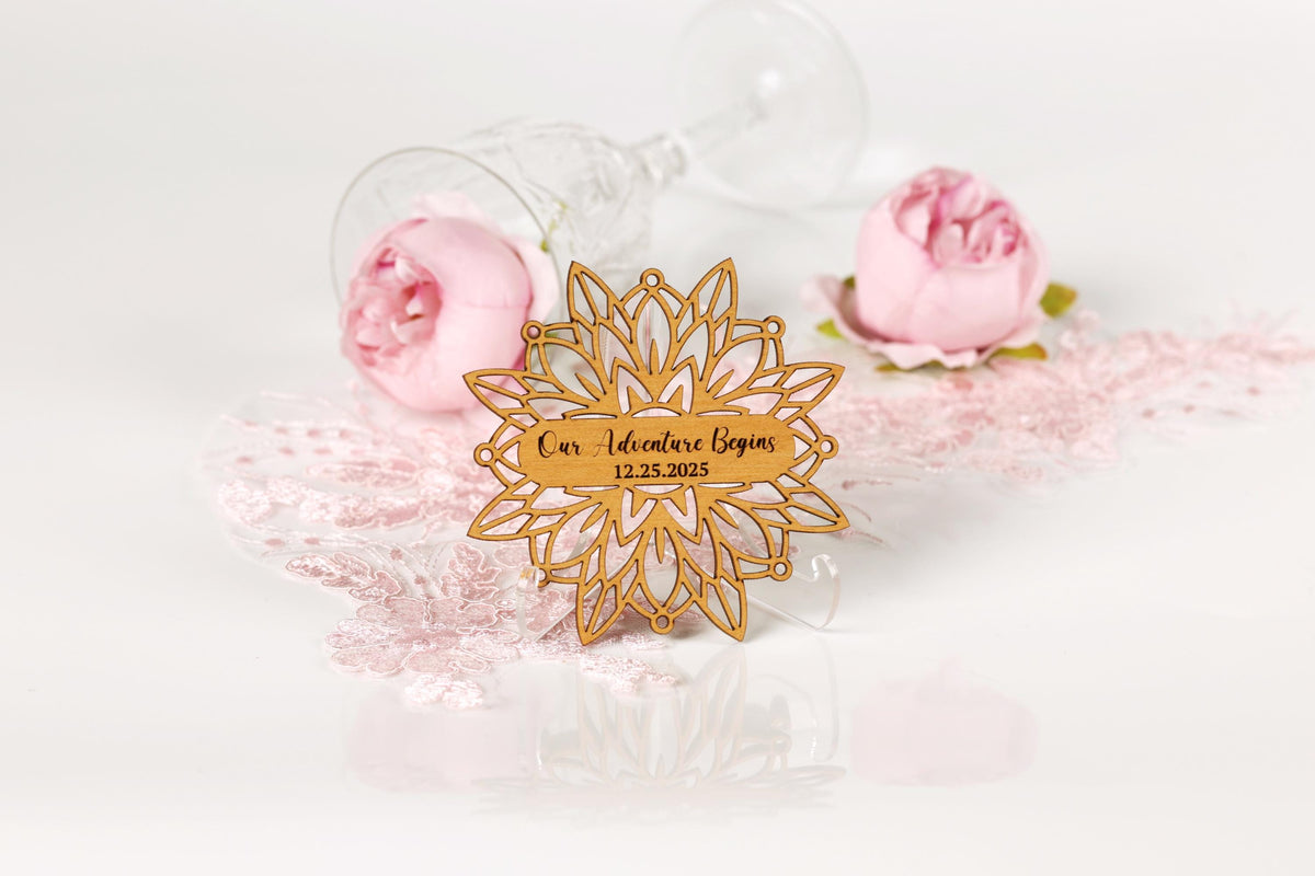 a wooden sign with a floral design, surrounded by pink roses and a glass of wine, with a lace doily on the surface.