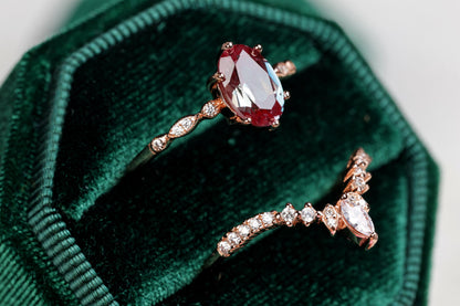 a couple of rings sitting on top of a green velvet bag