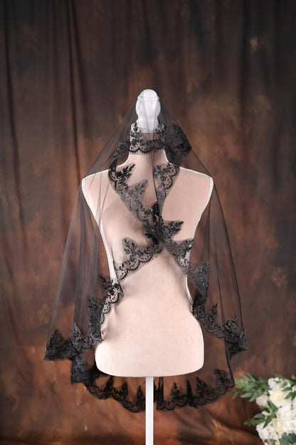 a mannequin with a black veil on top of it