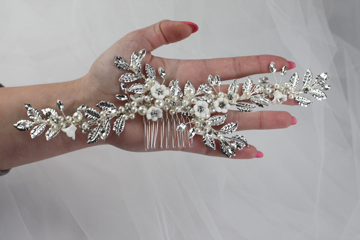 a woman's hand holding a bridal hair comb