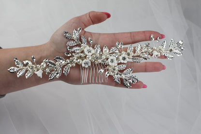 a woman's hand holding a bridal hair comb