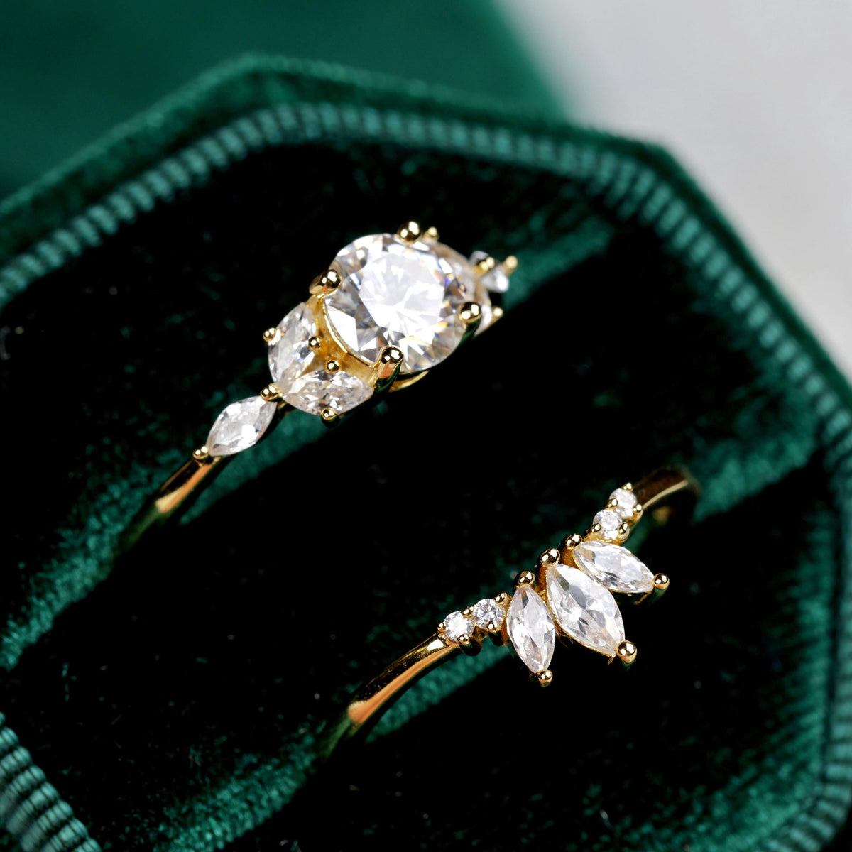 a couple of rings sitting on top of a velvet bag
