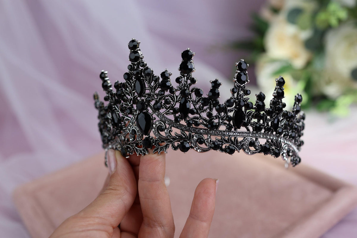 a woman holding a tiara in her hand