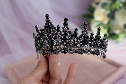 a woman holding a tiara in her hand