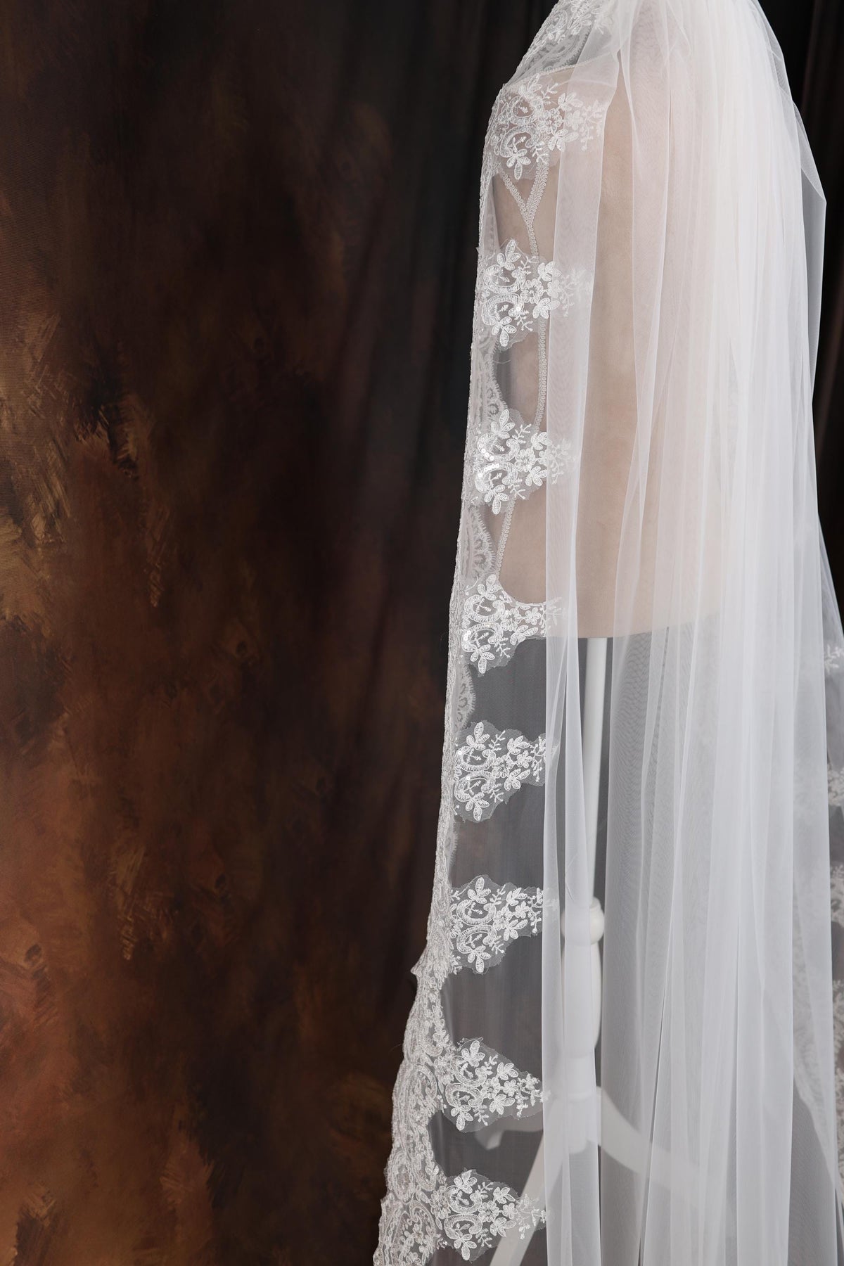 a woman wearing a white veil and a white dress