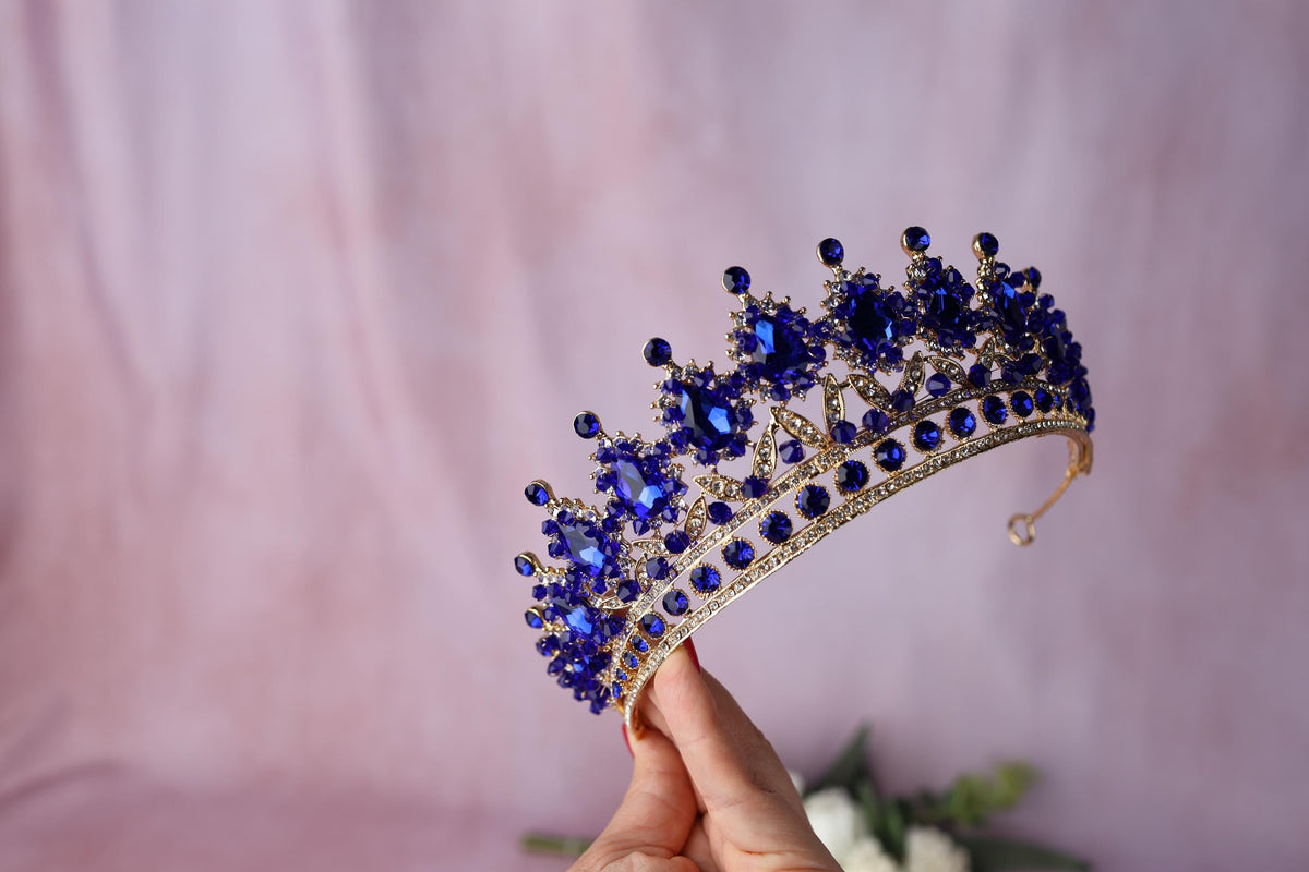 a woman holding a tiara in her hand