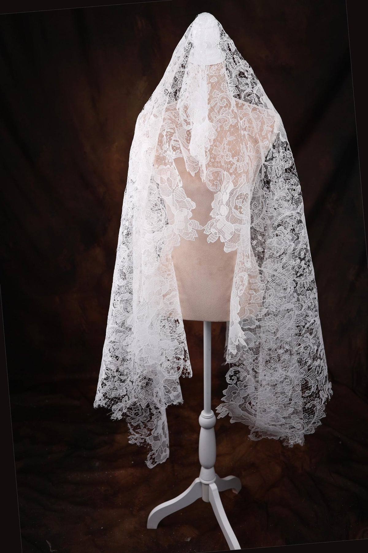 a white veil on a mannequin on a black background