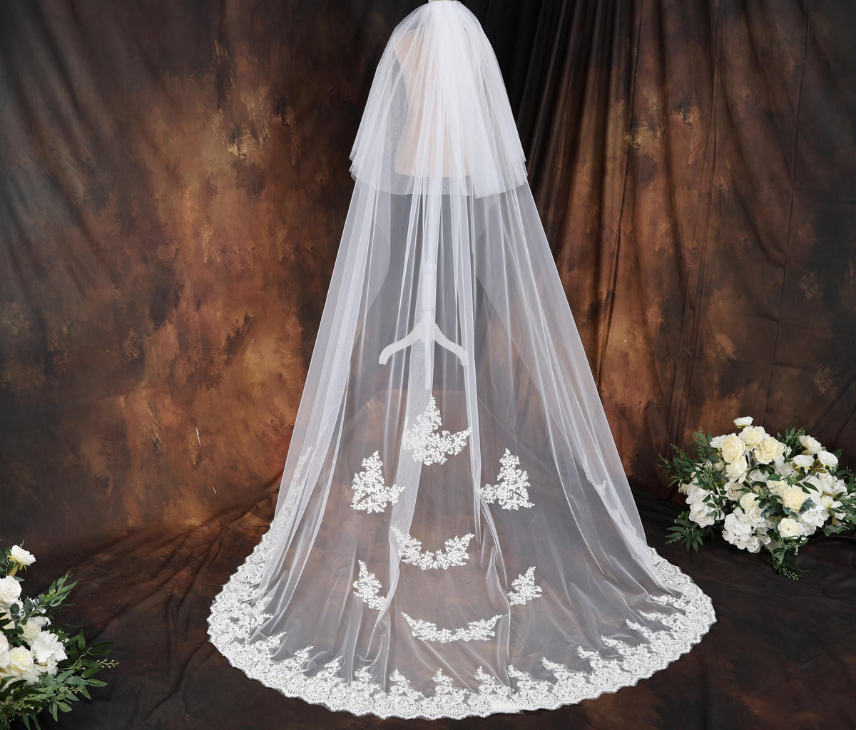 a bridal veil with a bouquet of white flowers