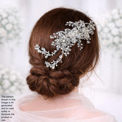 a woman's back view with her hair styled in a bun, wearing a decorative hair accessory with intricate floral and crystal elements.