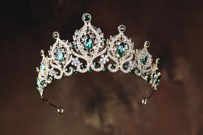 a tiara with green and white stones on it