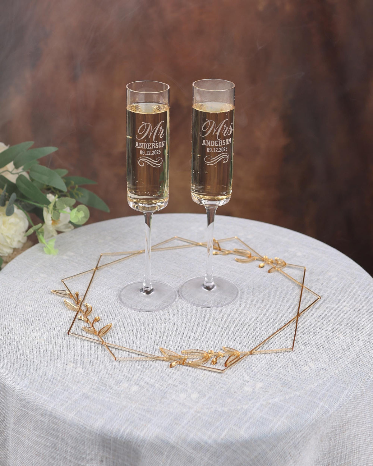 two glasses of champagne sitting on top of a table