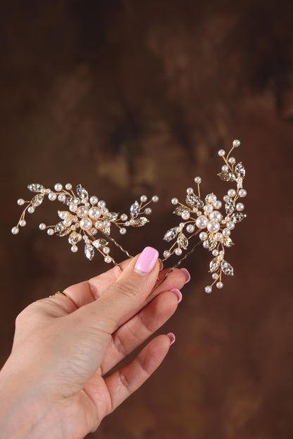 a woman's hand holding a bridal hair piece