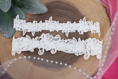 two white lace garters sitting on top of a piece of wood